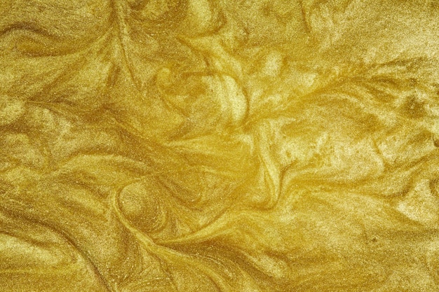 Liquide doré La surface ondulée de l'or qui coule Résumé fond scintillant