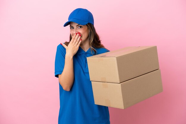 Livraison femme italienne isolée sur fond rose heureuse et souriante couvrant la bouche avec la main