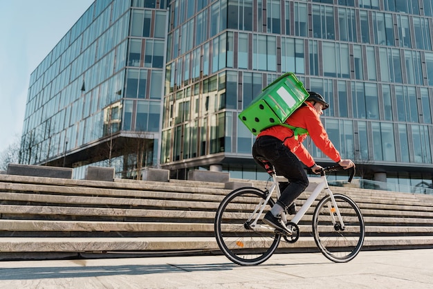 Livre le déjeuner sur commande du restaurant dans un sac thermos Un coursier à vélo