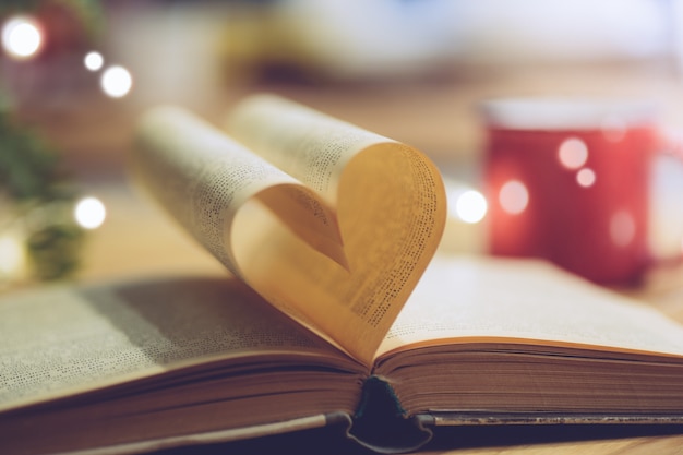 Livre ouvert avec une page en forme de coeur. Concept de connaissance, d'éducation ou d'amour