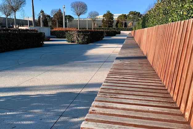 Long banc en bois dans un parc culturel moderne en été au coucher du soleil