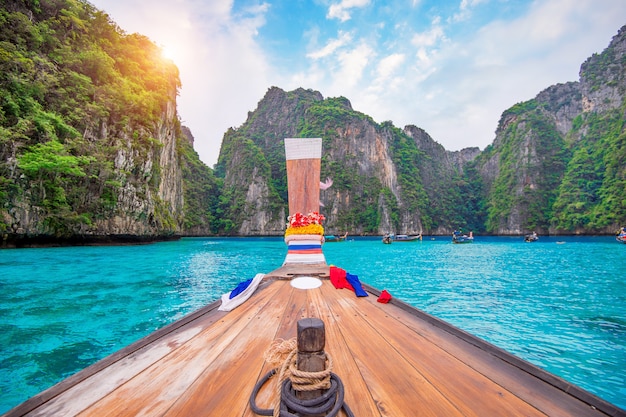 Photo long bateau et eau bleue à maya bay dans l'île de phi phi, krabi en thaïlande.