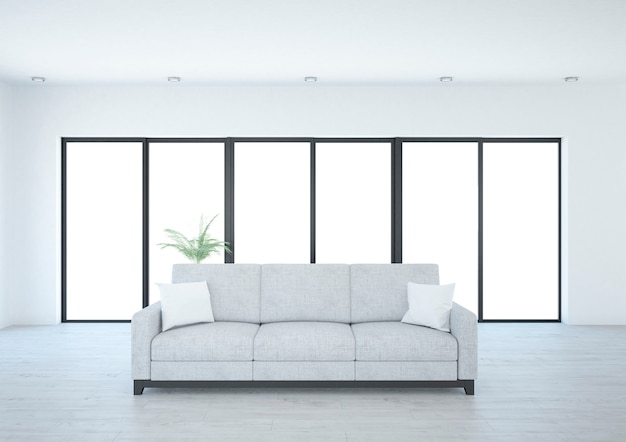 Long canapé gris dans la salle blanche avec fenêtres panoramiques