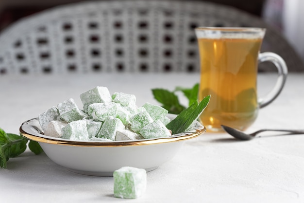 Loukoum lokum sur une assiette avec un verre de thé