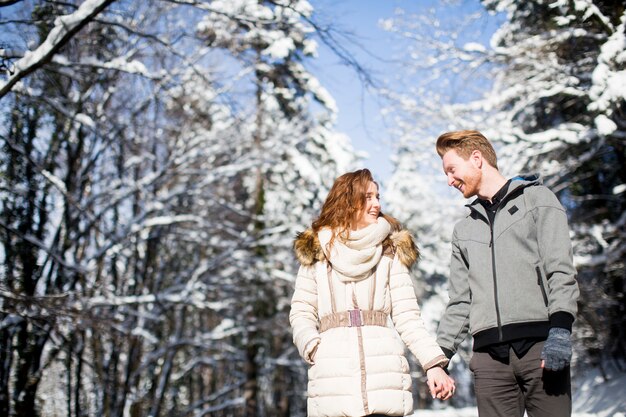 Loving jeune couple à la forêt d&#39;hiver