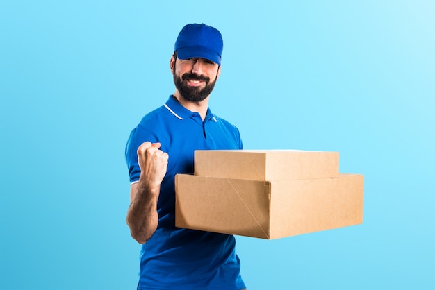 Lucky delivery man on colorful background