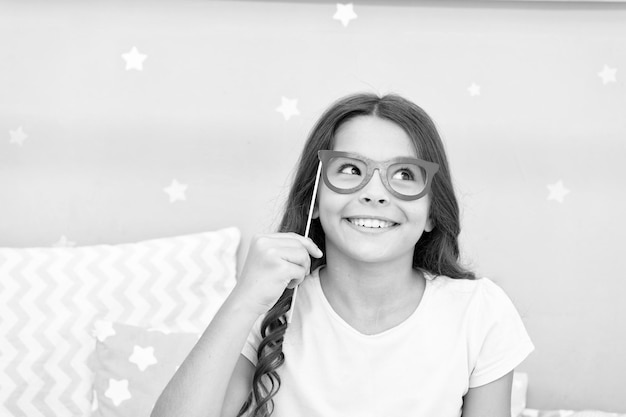 Ludique et funky Bonne petite fille Petite fille tient de fausses lunettes sur le visage Enfance heureuse J'ai une enfance très heureuse