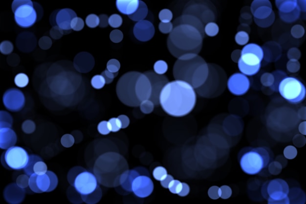Lumières bleues défocalisées sur fond sombre. Fond de Noël. bokeh