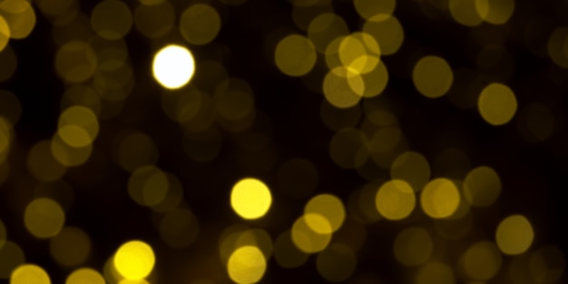 Lumières De Noël Or Défocalisé Sur Fond Sombre. Cercles De Bokeh Jaune Sur Fond Noir, Fond De Noël