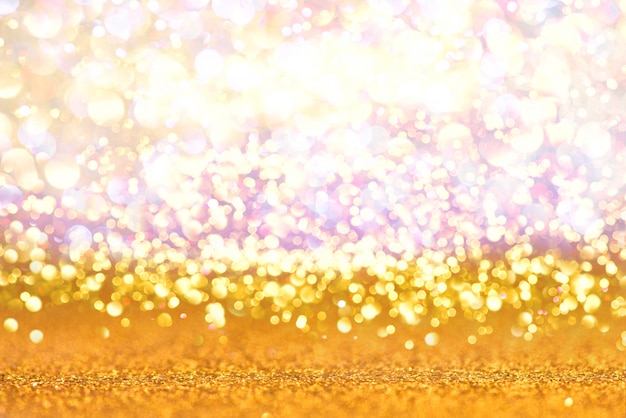 Photo lumières de paillettes d'or texture abstrait bokeh. défocalisé