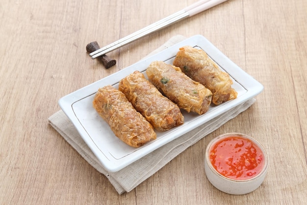 Lumpia Kulit Tahu, rouleaux de printemps au poulet et aux crevettes enveloppés dans de la peau de tofu. Servi avec sauce.