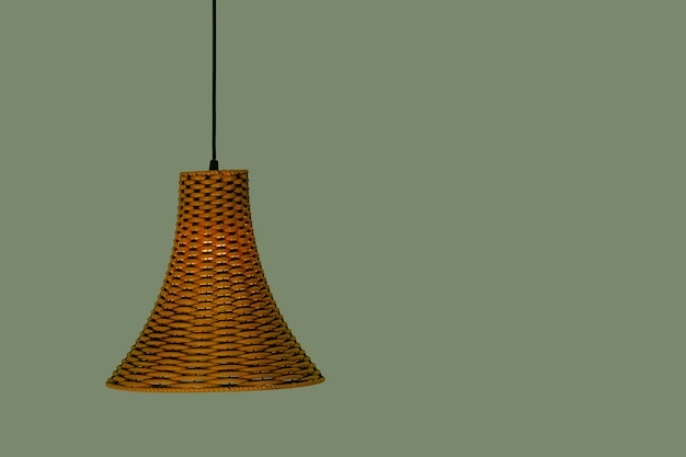 Lustre en sisal avec lumière allumée avec mur vert en arrière-plan