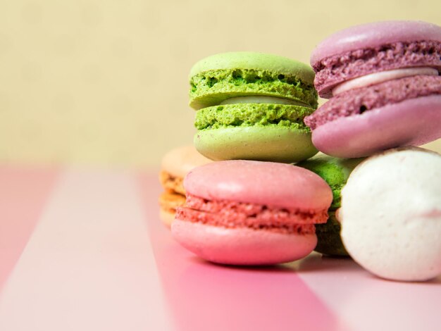 Macarons de biscuits de macaron de couleur fraîchement cuits au four, macarons sur un gros plan de plaque blanche,