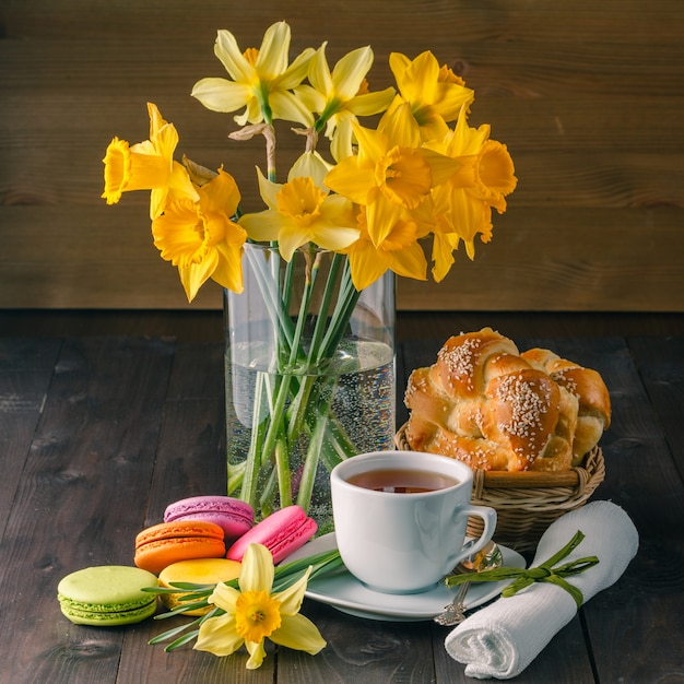 Macarons, tasse de café, pain et fleurs