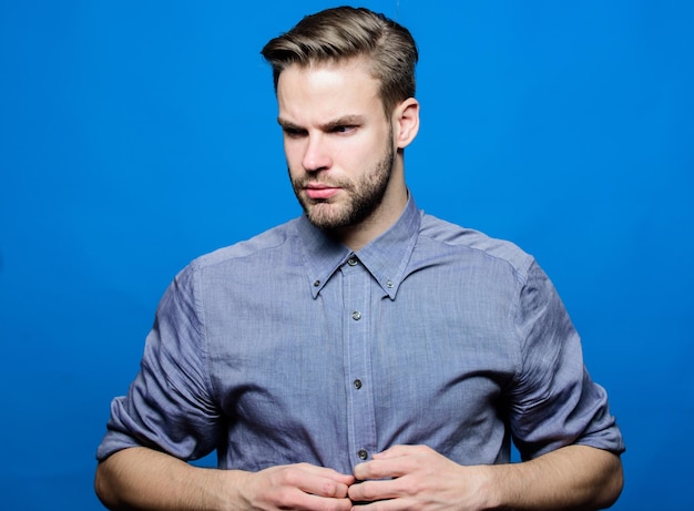 Macho bien soigné Soins du coiffeur et de la barbe Salon de toilettage de la barbe Salon de coiffure Toilettage de la barbe Préparez-vous pour la date La chemise en jean hipster a l'air attrayante sur fond bleu Homme barbe bien entretenue