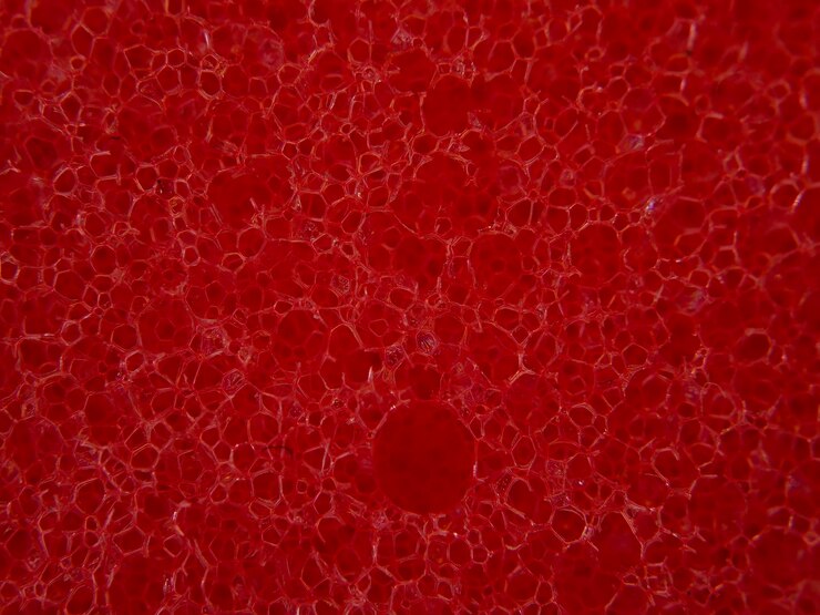 Photo macro extrême de texture d'éponge rouge
