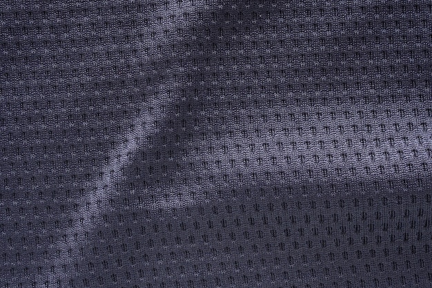Photo maillot de football de vêtements de sport en tissu noir avec fond de texture de maille d'air