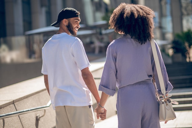 Main dans la main. Un couple marche dans la rue et se tient la main