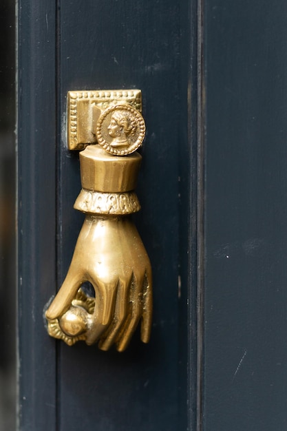 Photo une main dorée tenant une poignée de porte un un frappeur de porte à londres