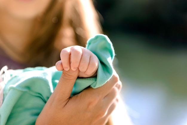 La main des enfants tient le doigt de la mère