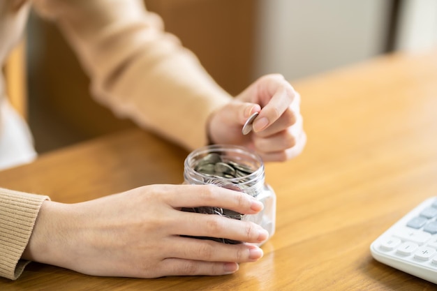 Une main féminine empile des pièces de monnaie en pleine croissance Économiser de l'argent financier ou un prêt pour se préparer à une future assurance financière