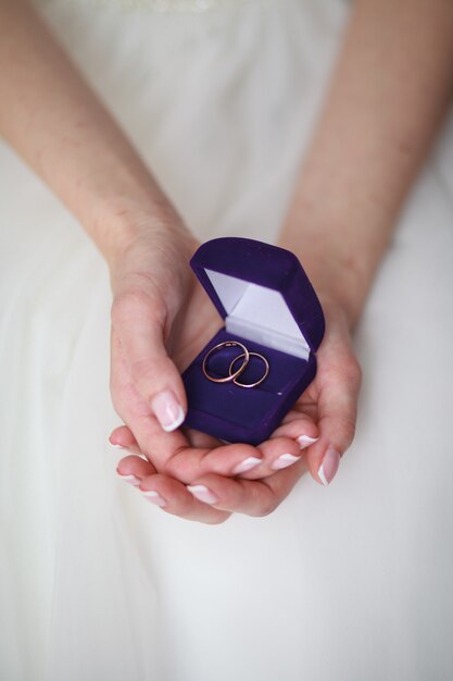 Main de femme tenant une boîte-cadeau avec bague de fiançailles