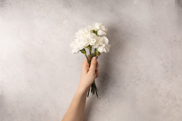 Main de femme tenant le bouquet de fleurs