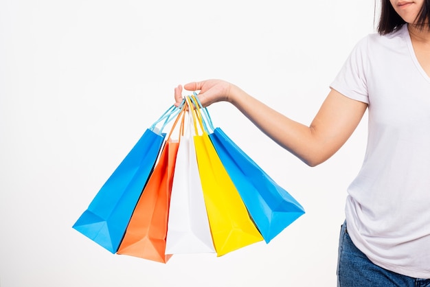 main de femme tenant des sacs multicolores