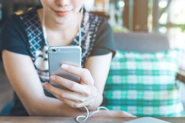 Main de femmes écoutent de la musique à partir de téléphones mobiles.