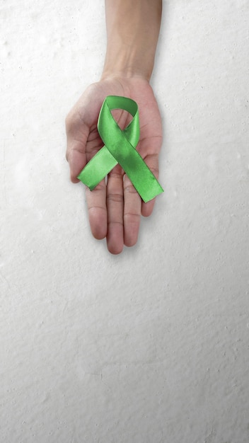 Photo main humaine montrant le ruban vert concept de la journée mondiale de la santé mentale