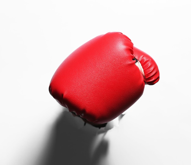 Photo main masculine dans un gant de boxe à travers du papier blanc isolé sur blanc