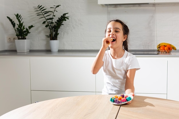 Main de petite fille décorant des bonbons faits maison.