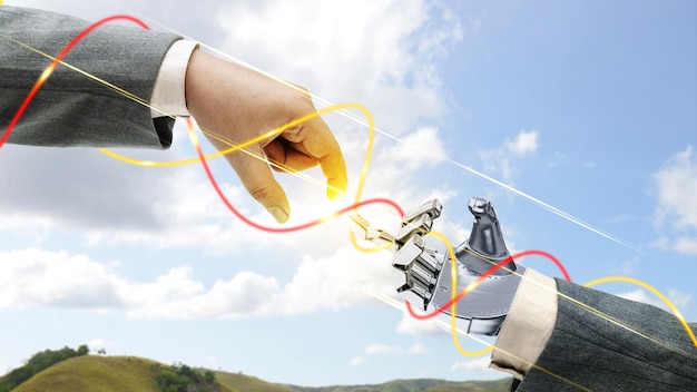 La main robotique et la main d'affaires avec le monde numérique