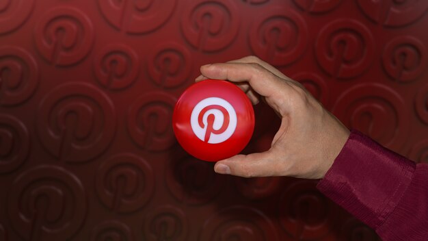 Photo une main tenant un badge brillant logo pinterest sur rouge