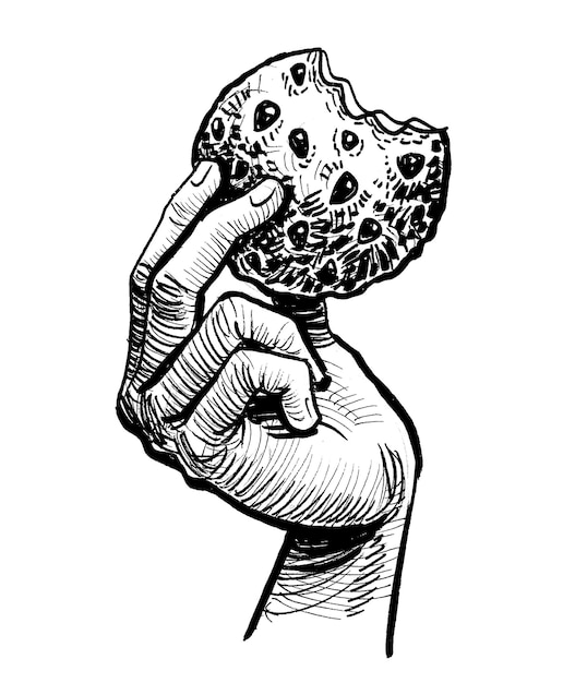 Une main tenant un cookie avec le mot " dessus " dessus
