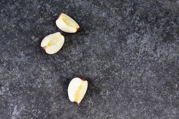 Les mains de bébé atteignent des pommes sur un fond sombre