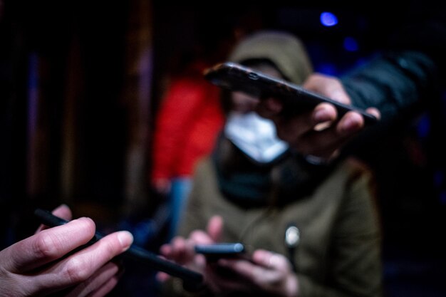 Photo des mains coupées de personnes tenant un téléphone portable