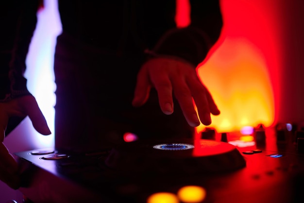 Photo mains de dj féminin jouant de la musique sur une platine de contrôleur midi moderne appareil numérique pour mixer de la musique lors d'événements et en studio