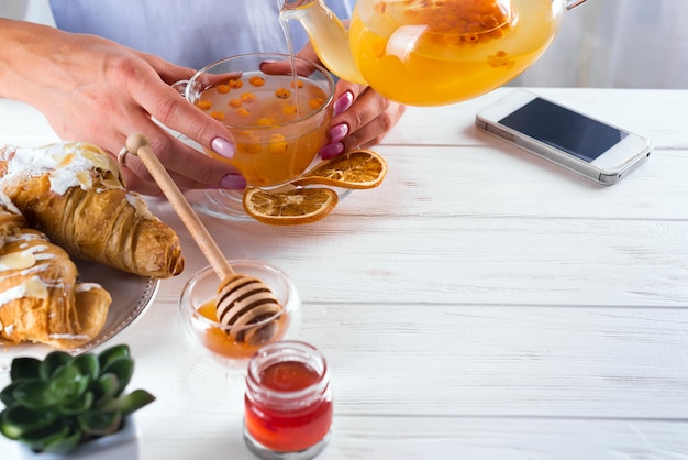 Mains féminines tenant une tasse de thé