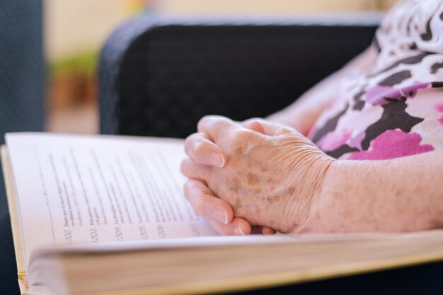 Mains d'une femme âgée avec la Bible