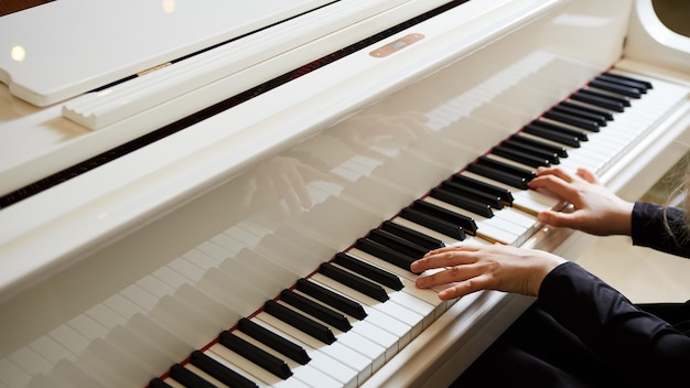Mains de femme sur le clavier du piano libre