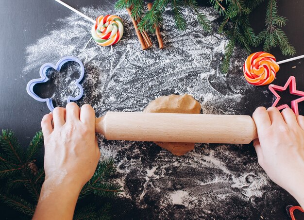 Mains de femme faisant la pâtisserie au gingembre, emporte-pièces