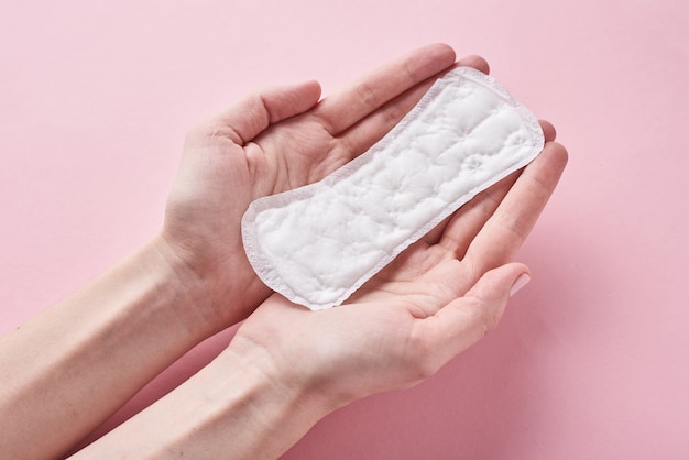 Mains de femme tenir un tampon sanitaire