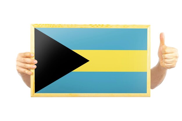 Mains tenant un cadre avec le drapeau des Bahamas idée de célébration du jour de l'indépendance ou concept de victoire