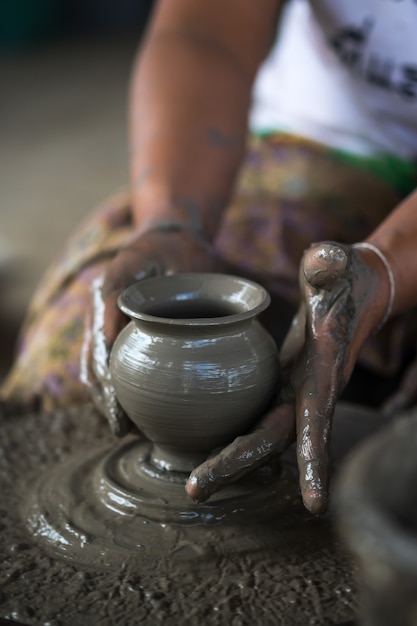 Mains travaillant sur la poterie