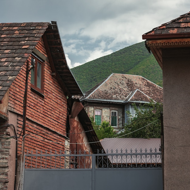 Maison ancienne au pied d'une montagne verte