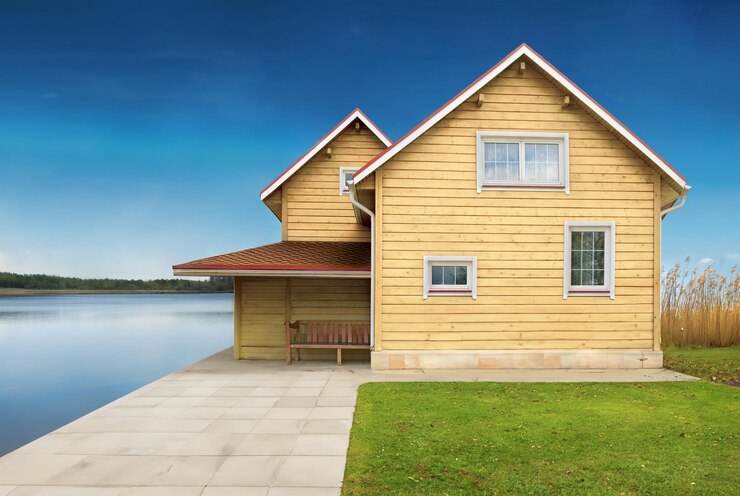 Photo une maison en bois près du lac.