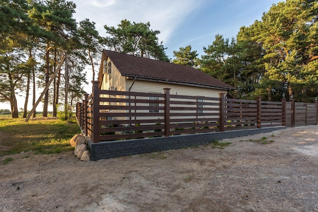 Maison de campagne écologique moderne dans une forêt de pins au coucher du soleil