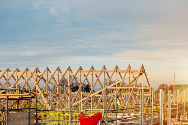 une maison construite en brique et en bois avec des fermes de toit en brique et des échafaudages