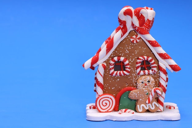 Maison de jouets de Noël avec Gingerbread Man sur fond bleu